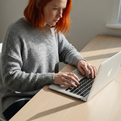 Person researching health supplements on a laptop, clean background
